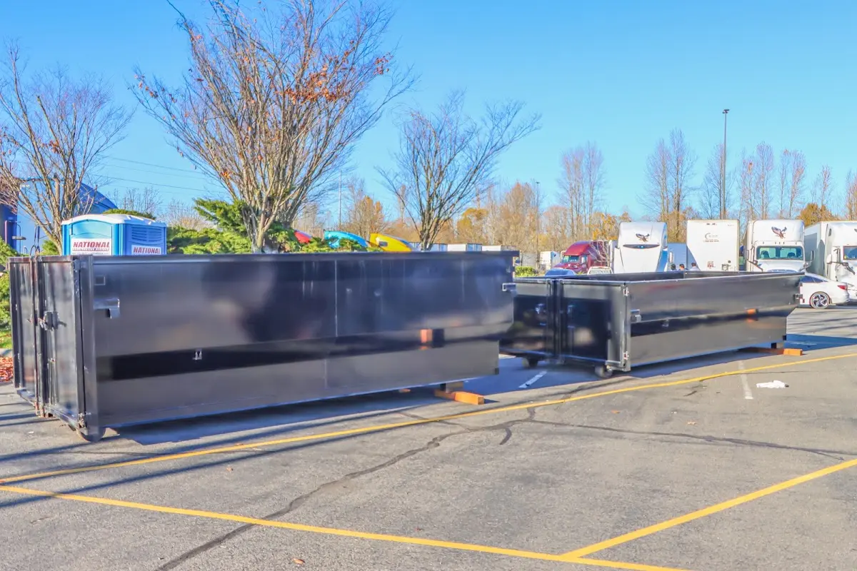 Professional dumpster rental service with roll-off container on residential driveway in Miamisburg